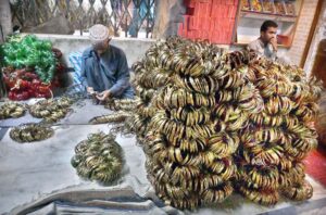 Workers are sorting and arranging bangles at the Bangle Market after preparing them, ready to be transported to other markets.