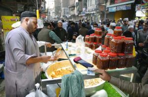 Vendor selling traditional dry fruit murabba to attract the customers during the holy fasting month of Ramzan-ul-Mubarak at Chowk Yadgar.