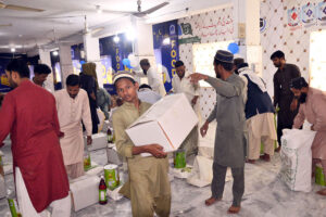 Deserving people receiving Ramadan Gift package by Alkhidmat foundation at Tabligh-e-Islam Makki Shah.