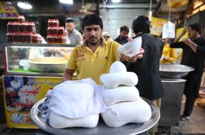 Vendor selling traditional dry fruit murabba to attract the customers during the holy fasting month of Ramzan-ul-Mubarak at Chowk Yadgar.