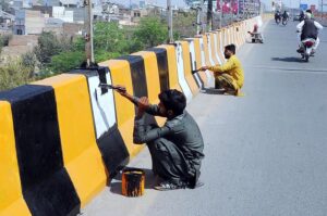 PHA staffers are busy painting on the wall of the kechehry fly over during beautification work in the city.