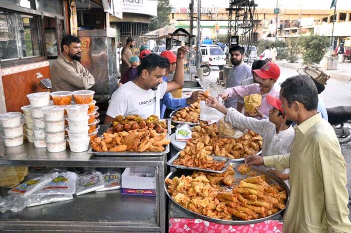 People purchasing traditional food items for iftari during the holy month of Ramazan at Latifabad