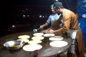 Vendors preparing traditional food stuff (Parathas) for Sehri at a local market during Holy Fasting Month of Ramzanul Mubarak