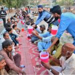 Volunteers distribute sweet drinks to the faithful for Iftar at a local park in Latifabad during the holy month of Ramadan