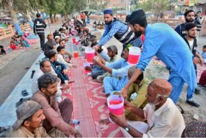 Volunteers distribute sweet drinks to the faithful for Iftar at a local park in Latifabad during the holy month of Ramadan