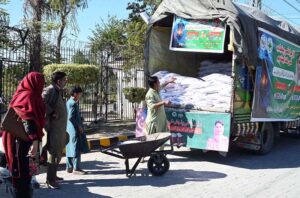 People busy purchasing subsidized floor outside 'Ramzan Sahulat Bazaar' setup during Holy Fasting Month of Ramadan at Murree road.