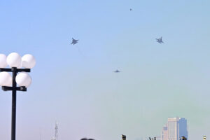 The Pakistan Air Force Karakoram-8 (K-8) aircraft team performs aerobatic manoeuvres during the National Day parade as they fly past near the President's House.