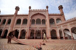 A volunteer diligently washes the floor of Sunehri Masjid before Namaz-e-Zohar during the holy month of Ramzan-ul-Mubarak