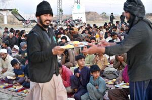 People are waiting for the Maghrib Azaan to break their fast near Islamabad Expressway during the holy fasting month of Ramadan.