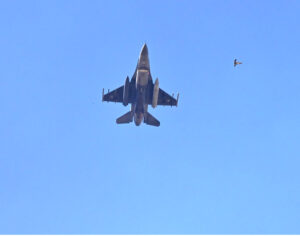 The Pakistan Air Force Karakoram-8 (K-8) aircraft team performs aerobatic manoeuvres during the National Day parade as they fly past near the President's House.