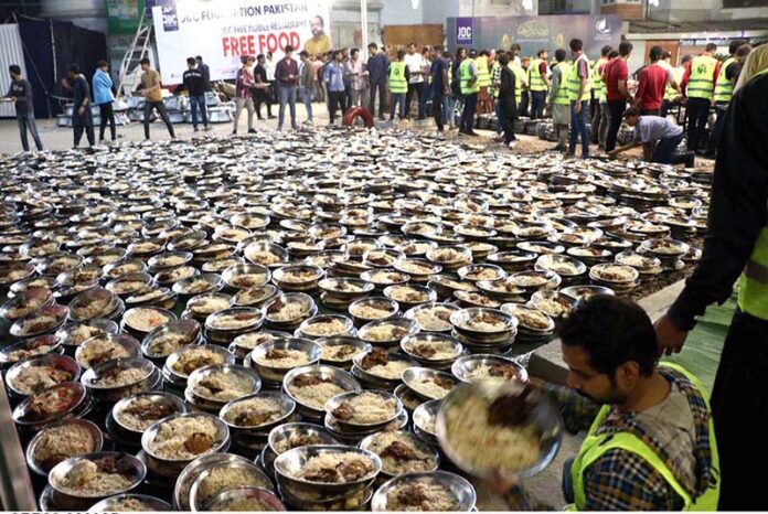 Volunteers prepare food to serve the families for first grant 'Sehri' during the holy fasting month of Ramzan ul Mubarak, free meal distribution by a JDC Foundation Pakistan near the mausoleum of the Quaid-i-Azam, Numaish Chowrangi