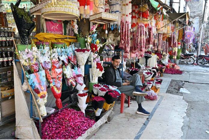 A vendor displaying flower bouquets to attract customers at flower Market Banni Chowk