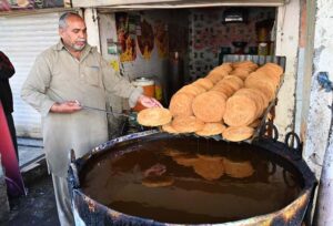 A vendor preparing traditional food item Pheoni in connection with Holy Fasting Month of Ramadan at Banni Chowk