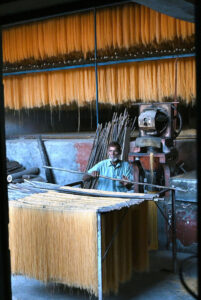 A worker busy in hanging vermicelli to dry after preparing it, as demand has increased during Eidul Fitr.