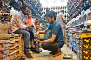 A worker is busy packing sandals into boxes at his workplace after preparing them, ready for transportation to other markets ahead of Eid-ul-Fitr.