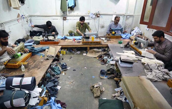 Tailors are occupied with sewing clothes for customers at their workplace in anticipation of the upcoming Eidul Fitr