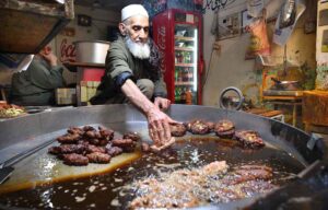 An elderly vendor busy preparing traditional ‘Chapli Kabab’ for customers at Cantt Bazaar during holy fasting month of Ramzan-ul-Mubarak.