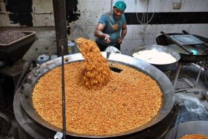 A worker busy in frying and preparing the traditional food item (Pakoriyaa) mostly used in ‘Dahi Bhalle’ during the holy fasting month of Ramzan.