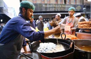 Worker busy in preparing traditional sweet item ‘Jalebi’ at Fawara Chowk during the holy fasting month of Ramzan-ul-Mubarak.