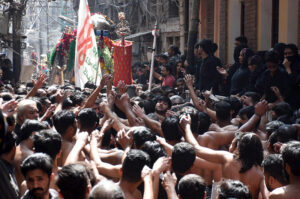 A procession is passing through the inner city near the Wazir Khan Mosque on the occasion of the martyrdom day of Hazrat Ali (RA).