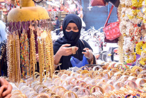 Customers at Chamra Market near Allama Iqbal Road purchasing leather Peshawari Chapal in preparation for the upcoming Eid-ul-Fitr