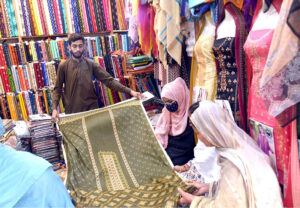 Customers at Chamra Market near Allama Iqbal Road purchasing leather Peshawari Chapal in preparation for the upcoming Eid-ul-Fitr