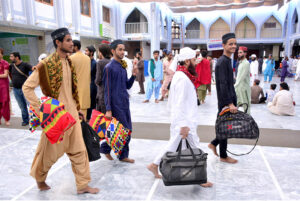 Worshipers entering in Faizan-E-Madina Mosque carrying their belongings to sit for Itikaf, an Islamic meritorious voluntary practice of secluding oneself in a mosque for a period of time, dedicating it to worship and spiritual reflection, typically during Ramadan