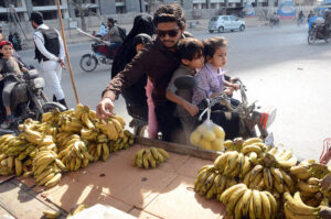 A family purchasing fruits for Iftar at Korangi area