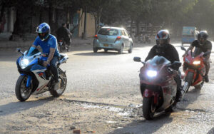 Youngsters enjoying riding heavy bikes near Governor House