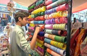 A vendor displaying and selling bangles at Urdu Bazaar.