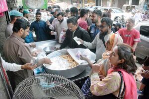 A vendor making a traditional sweet item (Jalebi) at Burns Road for iftar on the first day of holy fasting month of Ramazan