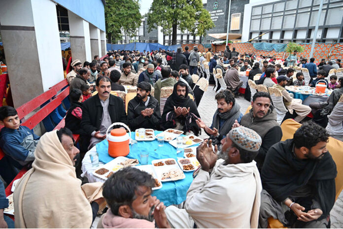 A large number of people offering Dua before breaking their fast at Allama Iqbal Memorial Teaching Hospital