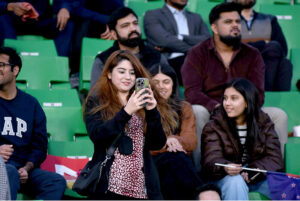 Spectators enjoying the ICC Champions Trophy one-day international (ODI) Semi-Final cricket match between New Zealand and South Africa at the Gaddafi Stadium