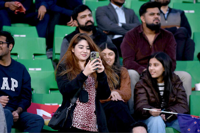 Spectators enjoying the ICC Champions Trophy one-day international (ODI) Semi-Final cricket match between New Zealand and South Africa at the Gaddafi Stadium