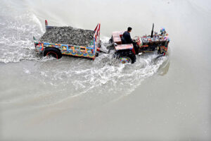 A tractor trolley loaded with river sand one of the fine sand used in concrete mixture, passing through Rice Canal