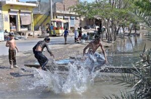 Youngsters enjoy taking bath in a canal. 