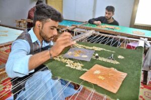 Artisans meticulously crafts intricate designs on a lady’s suit as demand rises ahead of Eid ul Fitr at Gurdat Singh Road.