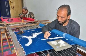 Artisans meticulously crafts intricate designs on a lady’s suit as demand rises ahead of Eid ul Fitr at Gurdat Singh Road.