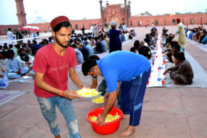 Volunteers distributing free food among the people for Iftar in Badshabad Shahi Mosque during the fasting month of Ramdan