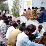 A large number of people breaking fast (Iftar) in the holy month of Ramzan ul Mubarak at road side in city