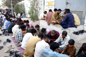 A large number of people breaking fast (Iftar) in the holy month of Ramzan ul Mubarak at road side in city