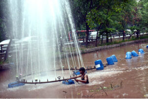 PHA worker busy repairing fountain at Canal Road.