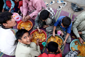 A large number of people breaking fast (Iftar) in the holy month of Ramzan ul Mubarak at road side in city