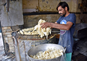 A shopkeeper preparing Pheniya late night in Krishna Nagar Chowk due to the increased demand during holy Ramadan