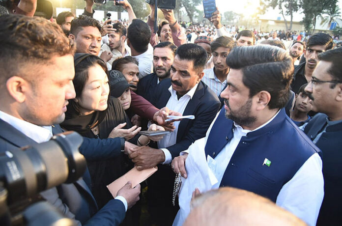 Sindh Governor Kamran Khan Tessori receives applications from the complaints during an Iftar reception to the common people at Governor House