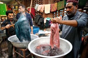 Workers busy in dying the clothes of customers at Cloth Market in the Provincial Capital.