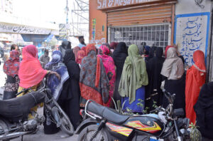 Women gathered round a franchise to collect financial assistance being provided by BISP.