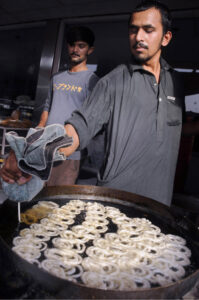 A jalebi-making vendor near Choubarji Chowk attracts customers by frying jalebis, used as a dessert in Iftar during the holy month of Ramadan