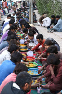 A large number of people break their fast at a free Iftar along the roadside in the holy month of Ramzan ul Mubarak.