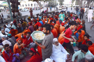 A large number of people break their fast at a free Iftar along the roadside in the holy month of Ramzan ul Mubarak.